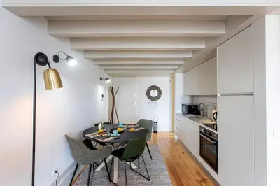 a kitchen and dining room with a table and chairs at São Bento Premium Loft - With Air Conditioning in Porto