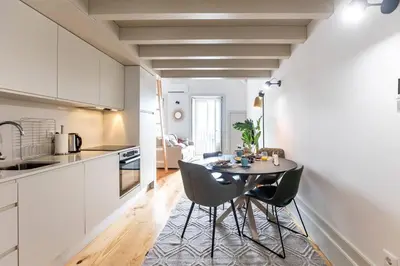 a kitchen and dining room with a table and chairs at São Bento Premium Loft - With Air Conditioning in Porto