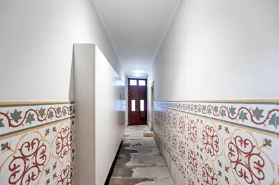 a hallway with red and white tiles and a door at Oporto Colorful Flat in Porto