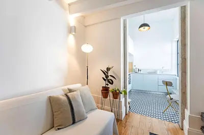 a living room with a white couch and a hallway at O Aleph, irresistible duplex apt. w/AC and balcony in Porto