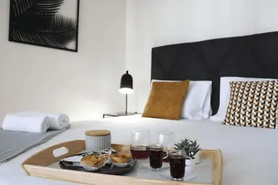 a tray with muffins and drinks on a bed at Luxury Porto Unique in Porto