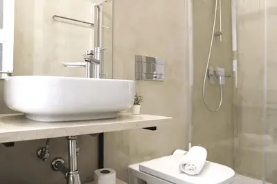 a bathroom with a sink and a shower and a toilet at Luxury Porto Unique in Porto