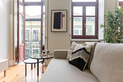 a living room with a couch and a table at Historical Sunny Marquês - With AC! in Porto