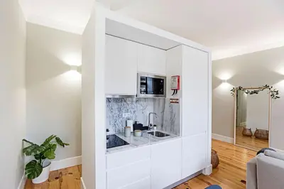 a living room with a large white wall at Historical Sunny Marquês - With AC! in Porto