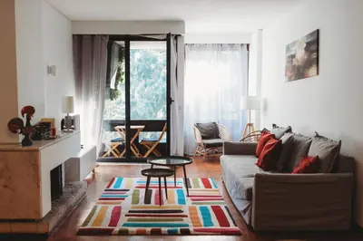 a living room with a couch and a fireplace at Bairro das arts in Porto