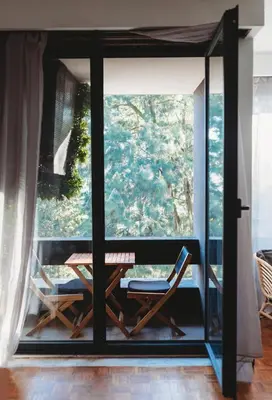 a room with a table and chairs and a window at Bairro das arts in Porto