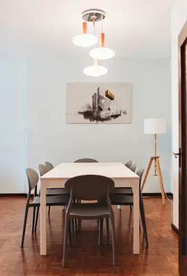 a dining room with a white table and chairs at Bairro das arts in Porto
