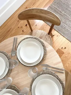 a wooden table with white plates and silverware on it at Fontainhas Douro Views by LovelyStay in Porto