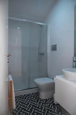 a bathroom with a shower and a toilet and a sink at Fontainhas Douro Views by LovelyStay in Porto