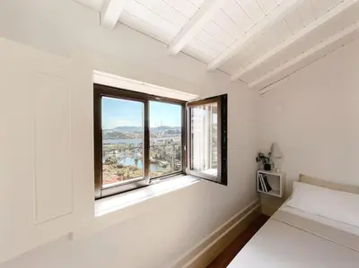 a white room with a bed and two windows at Fontainhas Douro Views by LovelyStay in Porto