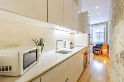 a kitchen with a microwave and a sink at Riverside Cozy Studio by LovelyStay in Porto
