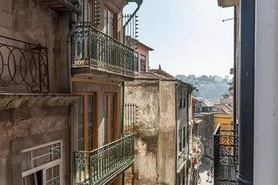 an old building with balconies on a city street at Riverside Cozy Studio by LovelyStay in Porto