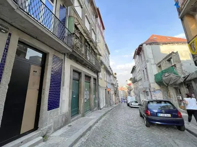 a small car parked on a cobblestone street at Caldeireiros Lovely Suite by Porto City Hosts in Porto