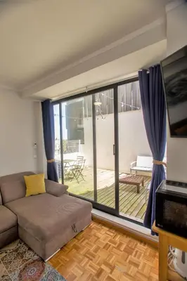 a living room with a couch and a balcony at Republica Square Apartment by Porto City Hosts in Porto