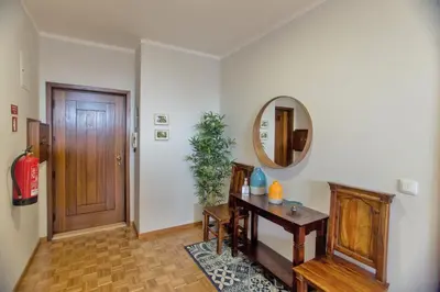 a hallway with a wooden table and a mirror at Republica Square Apartment by Porto City Hosts in Porto