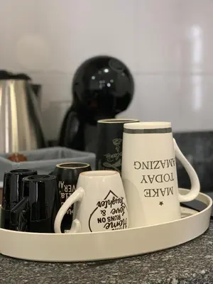 a tray with three coffee mugs on a counter at Almada Downtown 202 in Porto