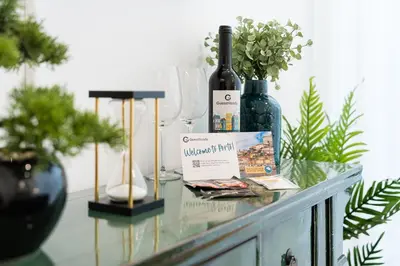 a glass table with wine bottles and glasses on it at GuestReady - Studio in Porto in Porto