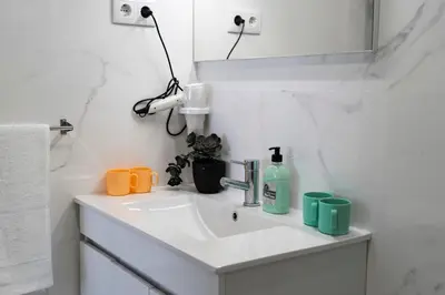 a bathroom with a sink and a mirror at Almada Downtown 203 in Porto
