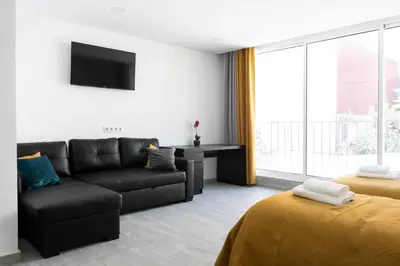 a living room with a couch and a tv at Almada Downtown 204 in Porto