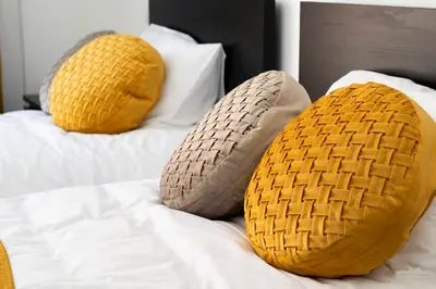 two knitted pillows on top of a bed at Almada Downtown 204 in Porto