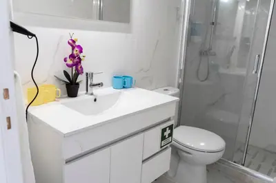 a bathroom with a sink and a toilet and a shower at Almada Downtown 301 in Porto