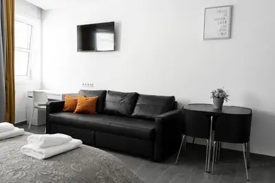 a living room with a black couch and a table at Almada Downtown 401 in Porto