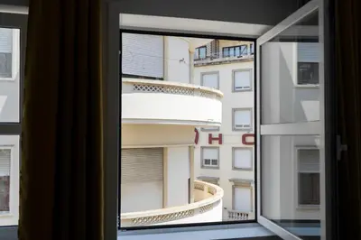 a window with a view of a building at Almada Downtown 401 in Porto