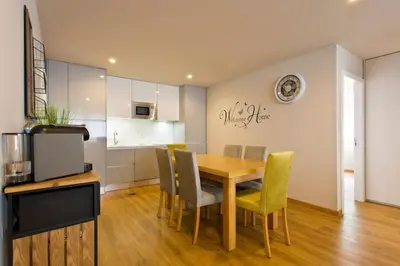 a kitchen and dining room with a wooden table and chairs at APOSENTUS - Marta's House in Porto