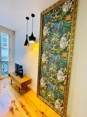 a large painting on the wall in a room with a table at Oporto Chic & Cozy - Mercadores in Porto