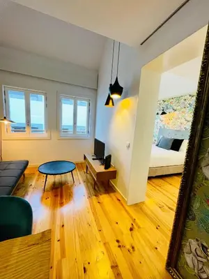 a living room with a bed and a couch and a table at Oporto Chic & Cozy - Mercadores in Porto