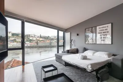 a bedroom with a bed and a large window at MY DOURO VIEW Stunning Apartment River Front in Vila Nova de Gaia