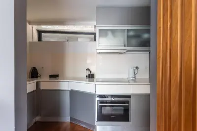 a kitchen with white counters and a sink and a microwave at MY DOURO VIEW Stunning Apartment River Front in Vila Nova de Gaia