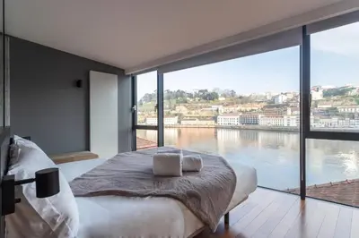 a bedroom with a large view of the water at MY DOURO VIEW Stunning Apartment River Front in Vila Nova de Gaia