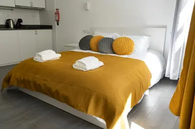 a bedroom with a large bed with towels on it at Almada Downtown 101 in Porto
