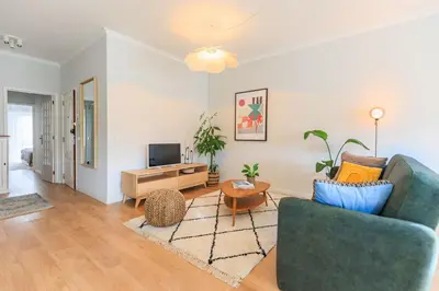 a living room with a couch and a tv at Enjoy Bonfim Central 2BR Renovated Apartment by LovelyStay in Porto