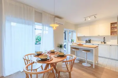 a kitchen and dining room with a table and chairs at Enjoy Bonfim Central 2BR Renovated Apartment by LovelyStay in Porto