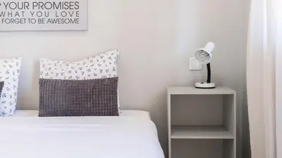 a bedroom with a bed with a pillow and a lamp at Delightful Bombarda Apartment by Unique Hosts in Porto