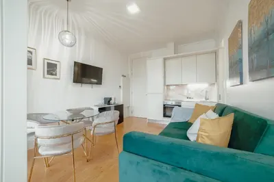 a living room with a blue couch and a table at Downtown Premium Apartment by Vacationy in Porto