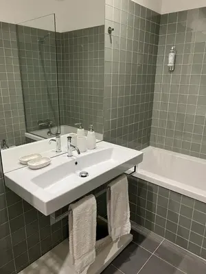 a bathroom with a white sink and a bath tub at Oporto Chic & Cozy Cardosas in Porto