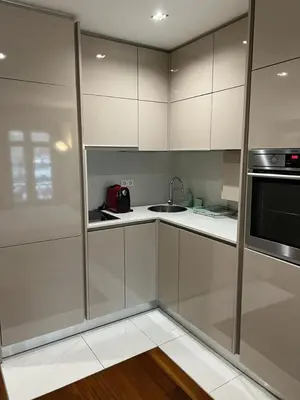 a kitchen with white cabinets and a sink and a microwave at Oporto Chic & Cozy Cardosas in Porto