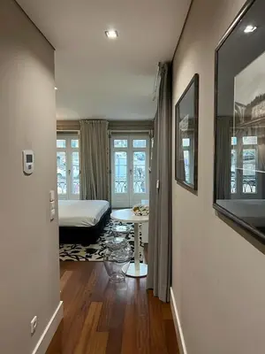 a bedroom with a bed and a table in a room at Oporto Chic & Cozy Cardosas in Porto