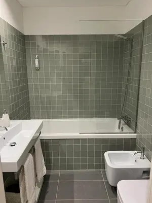 a bathroom with a tub and a toilet and a sink at Oporto Chic & Cozy Cardosas in Porto