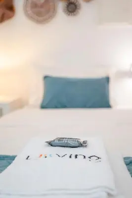 a bed with a pillow with a fish on it at Liiiving in Porto - Heart of Porto Mezzanine in Porto