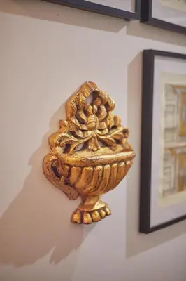 a gold bowl on a wall next to a picture at Maison214 in Vila Nova de Gaia