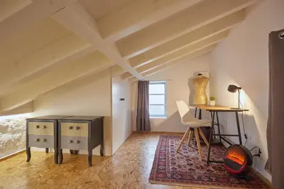 a room with a desk and a table and a chair at Maison214 in Vila Nova de Gaia