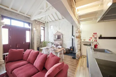a living room with a red couch and a table at Maison214 in Vila Nova de Gaia