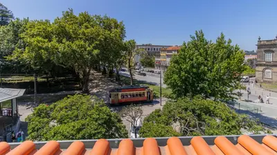 a bus is parked in a parking lot with trees at Aposentus - Stylish Downtown Loft in Porto