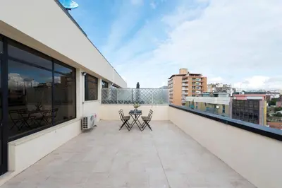 a balcony with a table and chairs and a view at DOISPONTOZERO Júlio Dinis in Porto