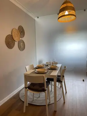 a dining room with a wooden table and chairs at Lindo apartamento em Gaia ao lado Bodegas in Vila Nova de Gaia
