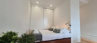 a bedroom with a bed with a mirrored wall at Merc Porto Estudio 245 in Porto